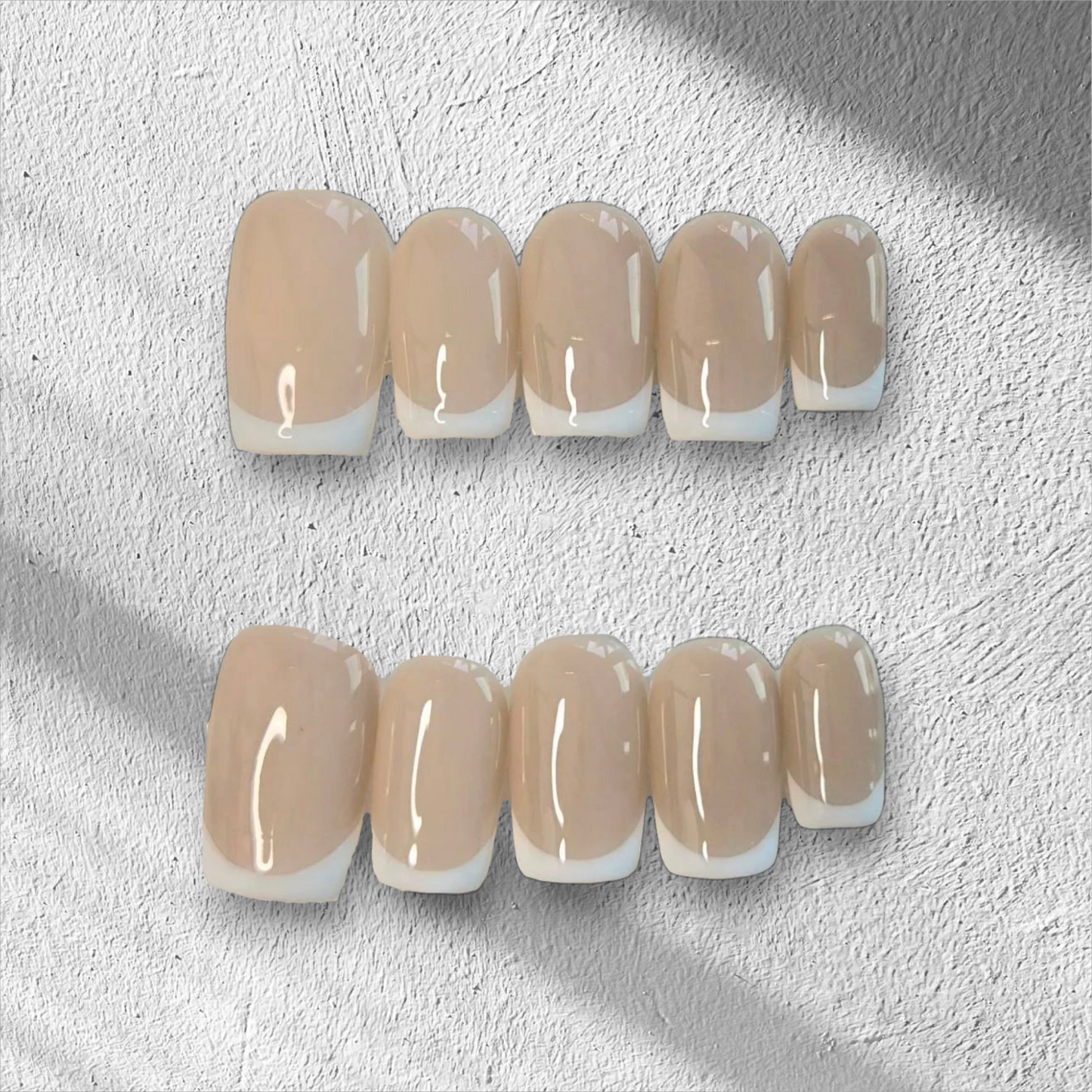 Flora classic French tip press-on nails, short square shape, with a delicate pink base and crisp white tips.