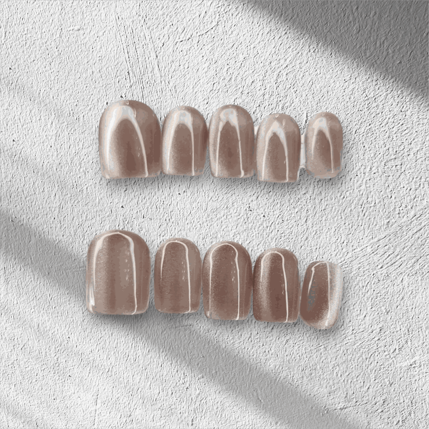 Nude beige glossy press-on false nails set on textured white surface with soft shadow lighting