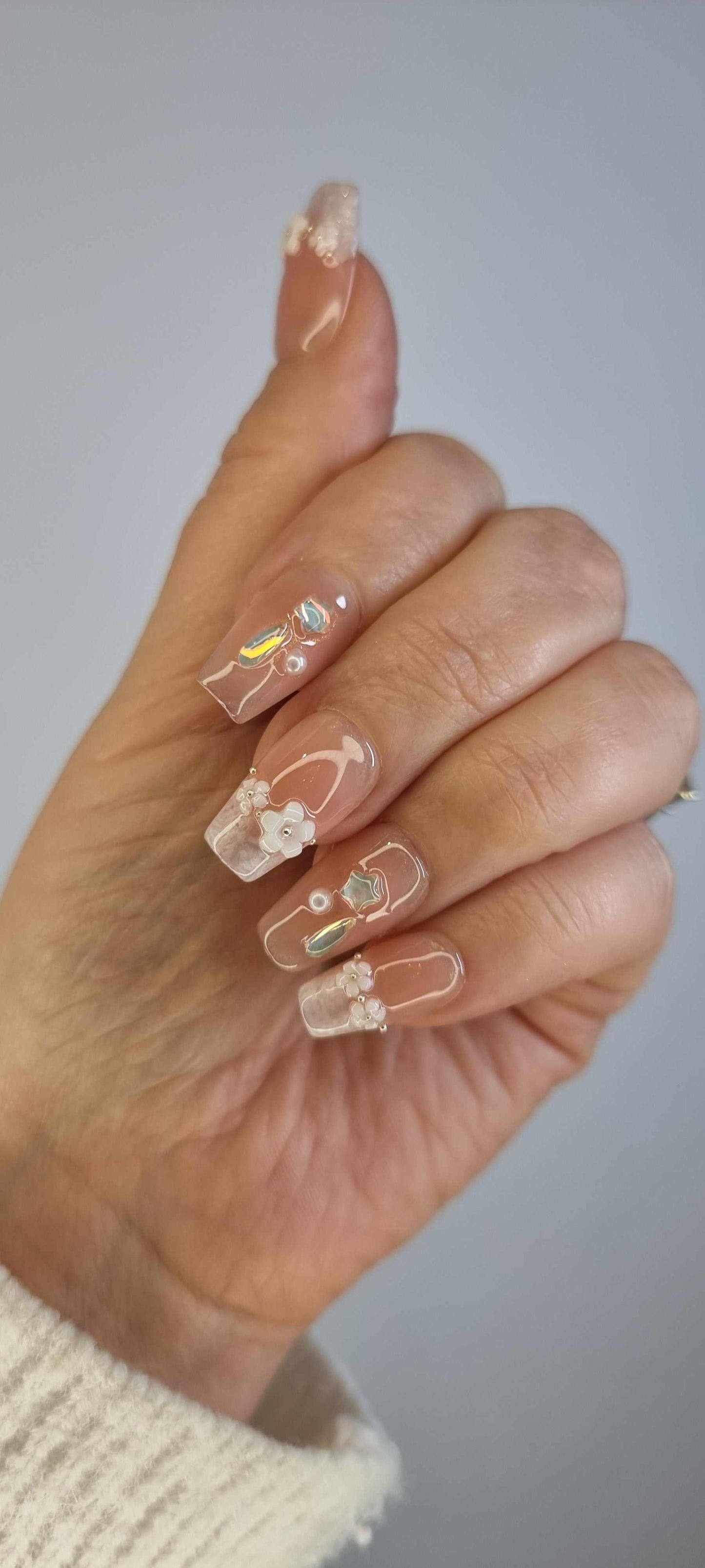 Close-up of a hand wearing the Aziza or Salina press-on nail set.