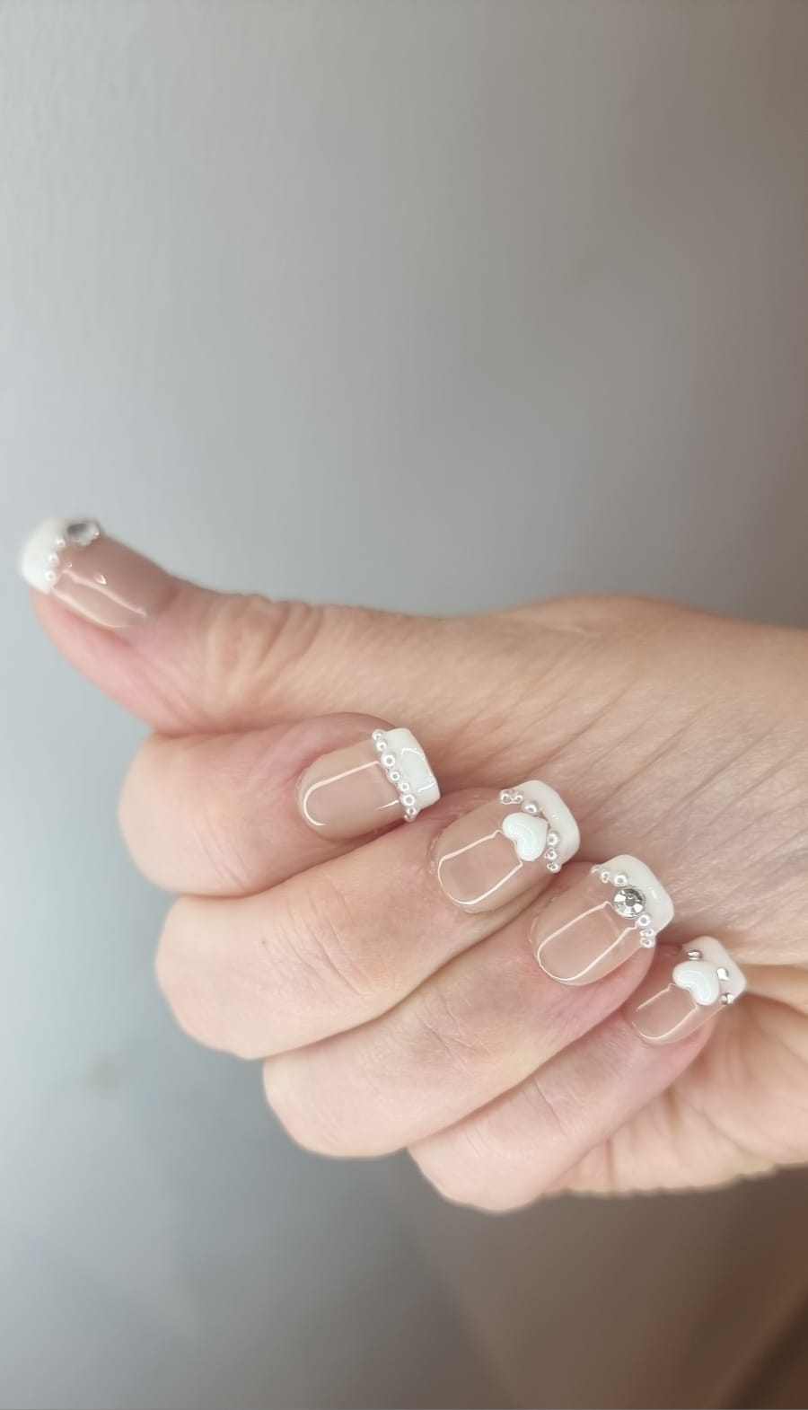 Close-up of a model wearing the Burj Beauty French manicure press-on nails.