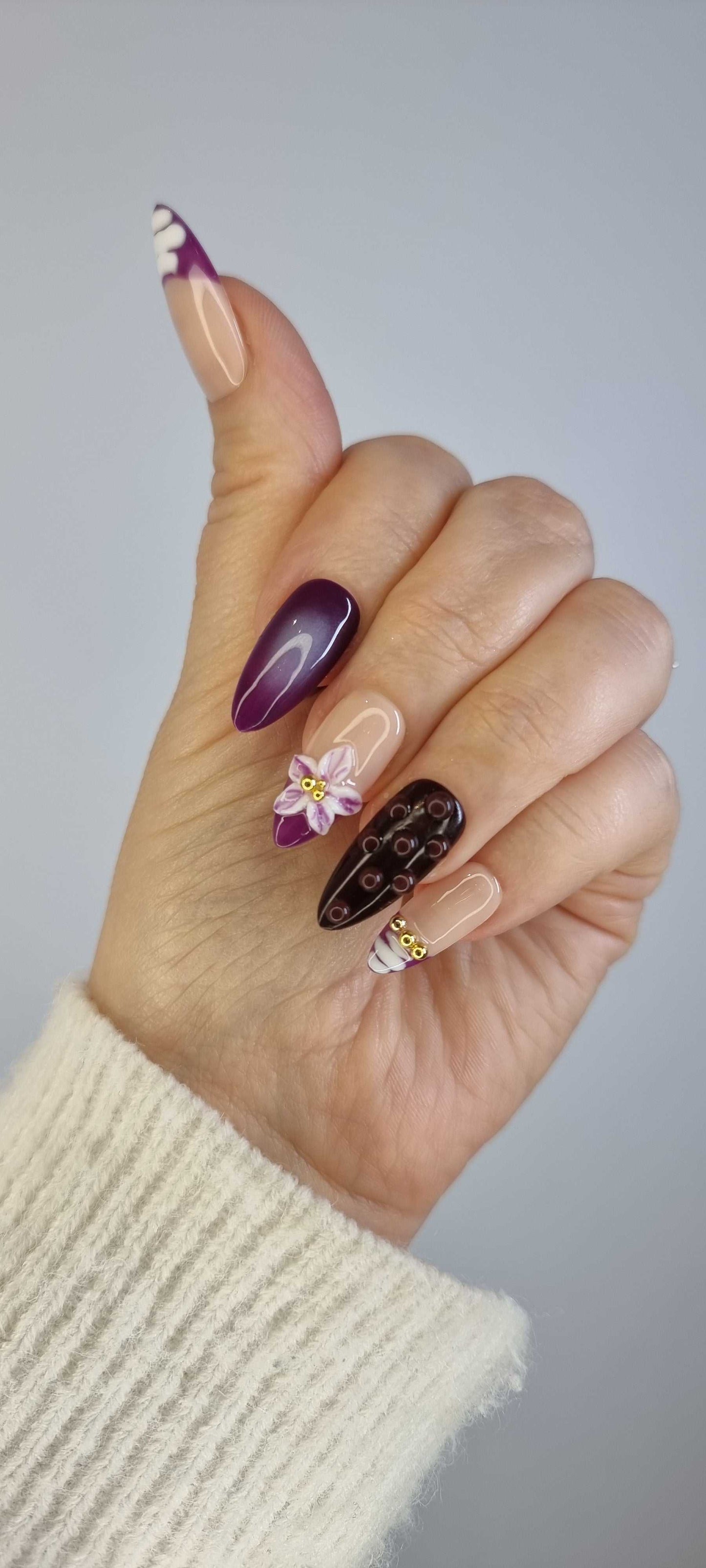 A close-up of the Emirati Essence manicure, highlighting the detailed, henna-style artwork and luxurious finish of the press-on nails.