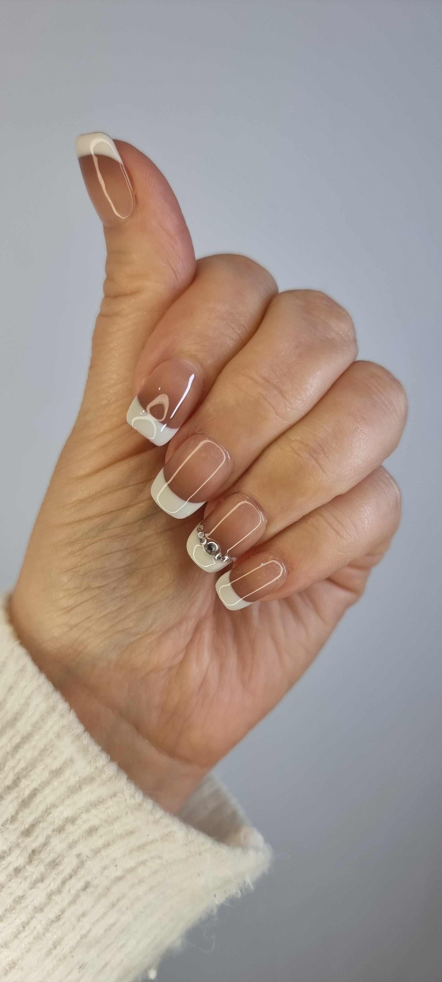 Hand wearing Hues of Hatta press-on nails by Nail Addict, highlighting the two-toned design and the short square shape.