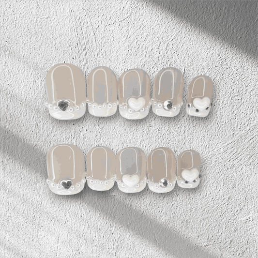 Nada pink French tip long coffin press-on nails by Nail Addict, with a white and gold glitter accent nail.