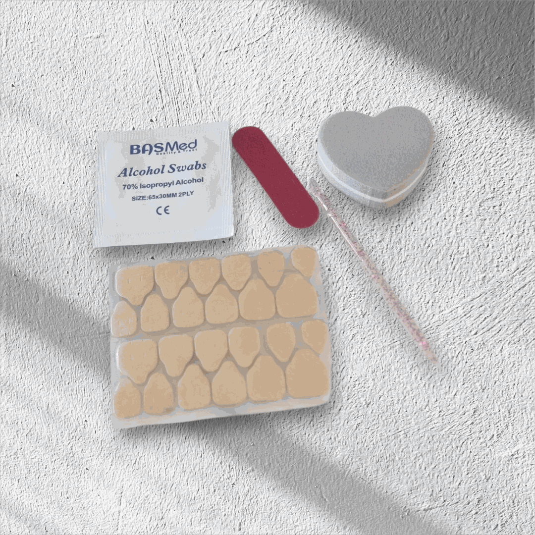 Press on nail application kit with swabs, nail file, heart-shaped buffer, and reusable press-on nails for easy salon-quality manicures.