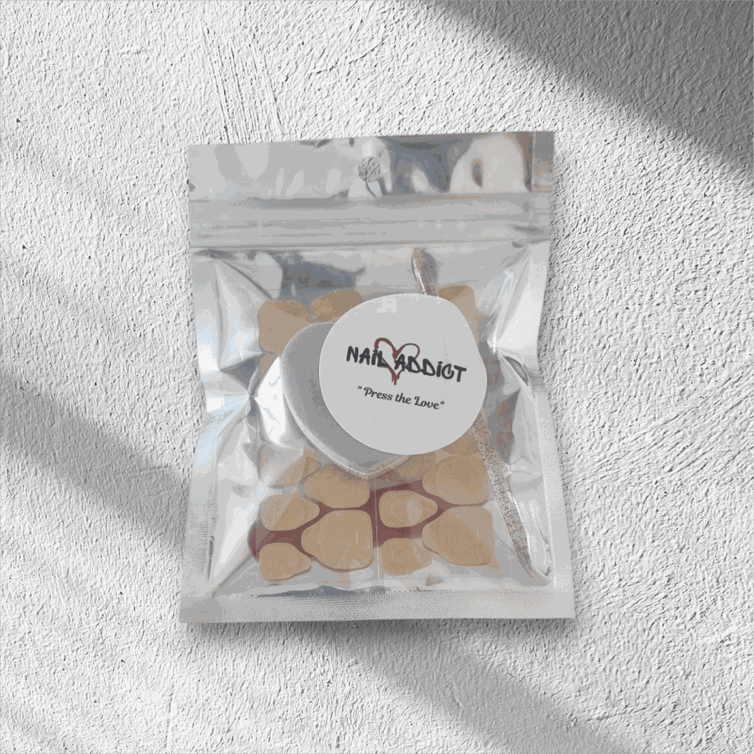 Press on nail application kit in resealable pouch with nail glue included for easy, reusable salon-quality nails.