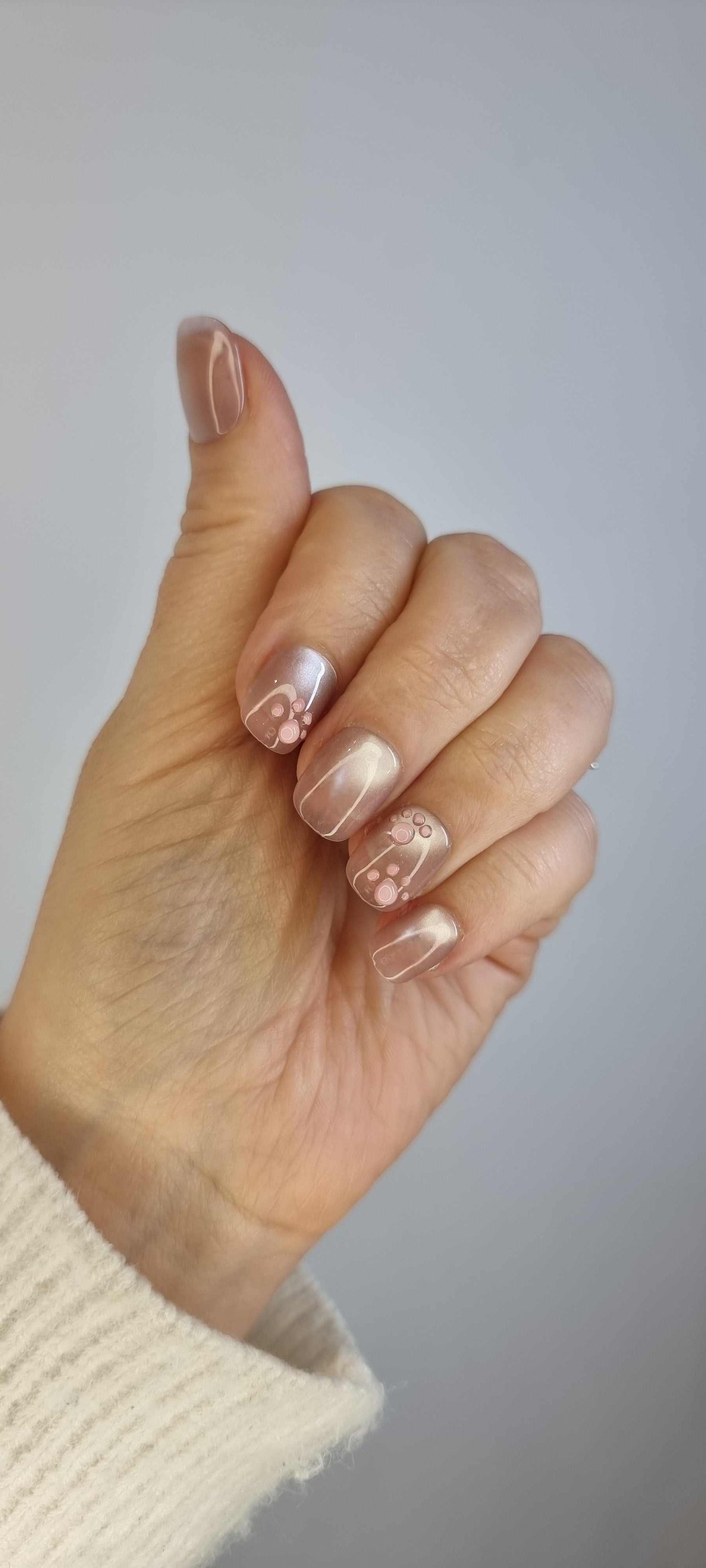 Set of Qita glossy, neutral-toned press-on nails, showing the finished manicure.
