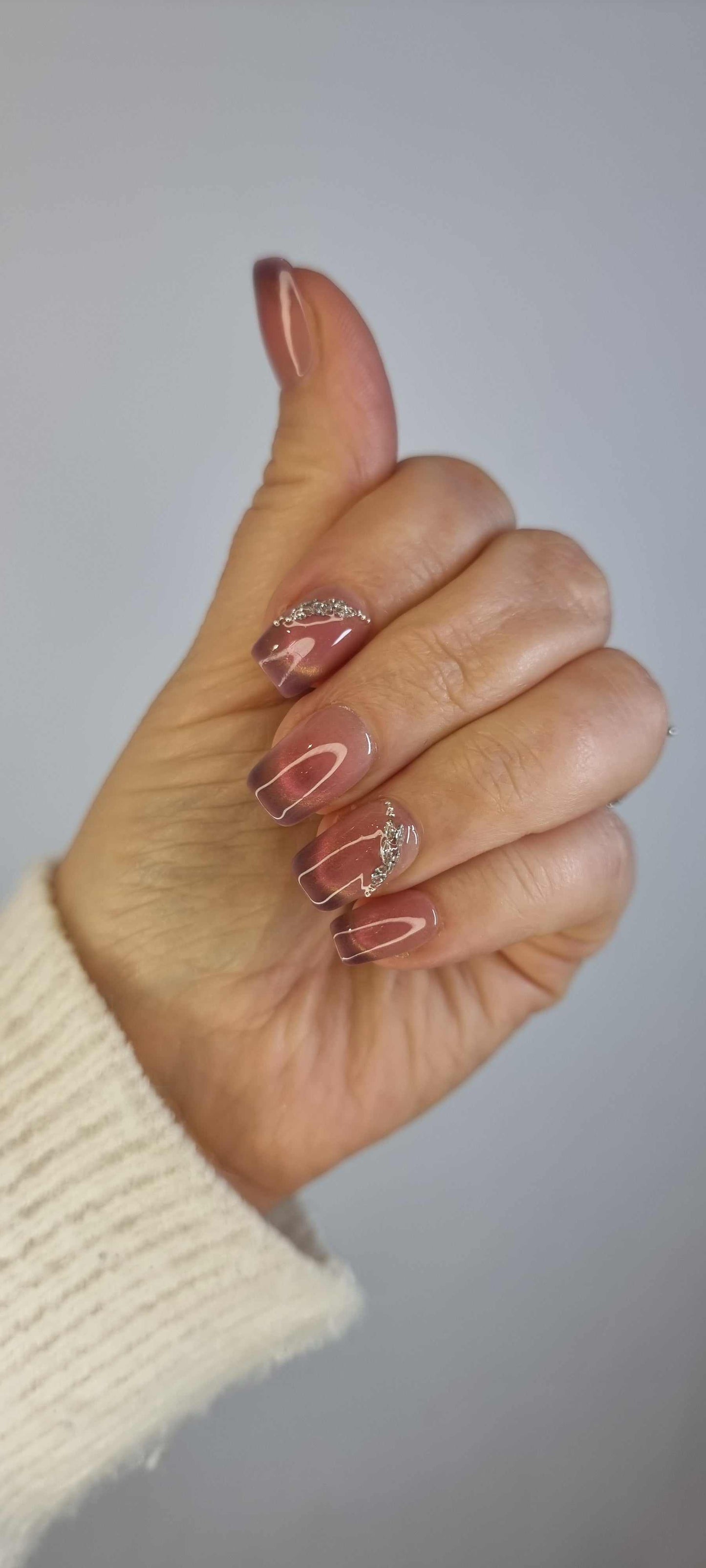 Set of Souq Secrets long, square-shaped press-on nails, showing length and style.