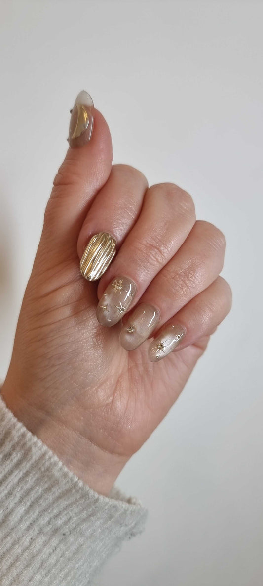 Close-up image of the UAE Glow glossy, light-toned press-on nails set.