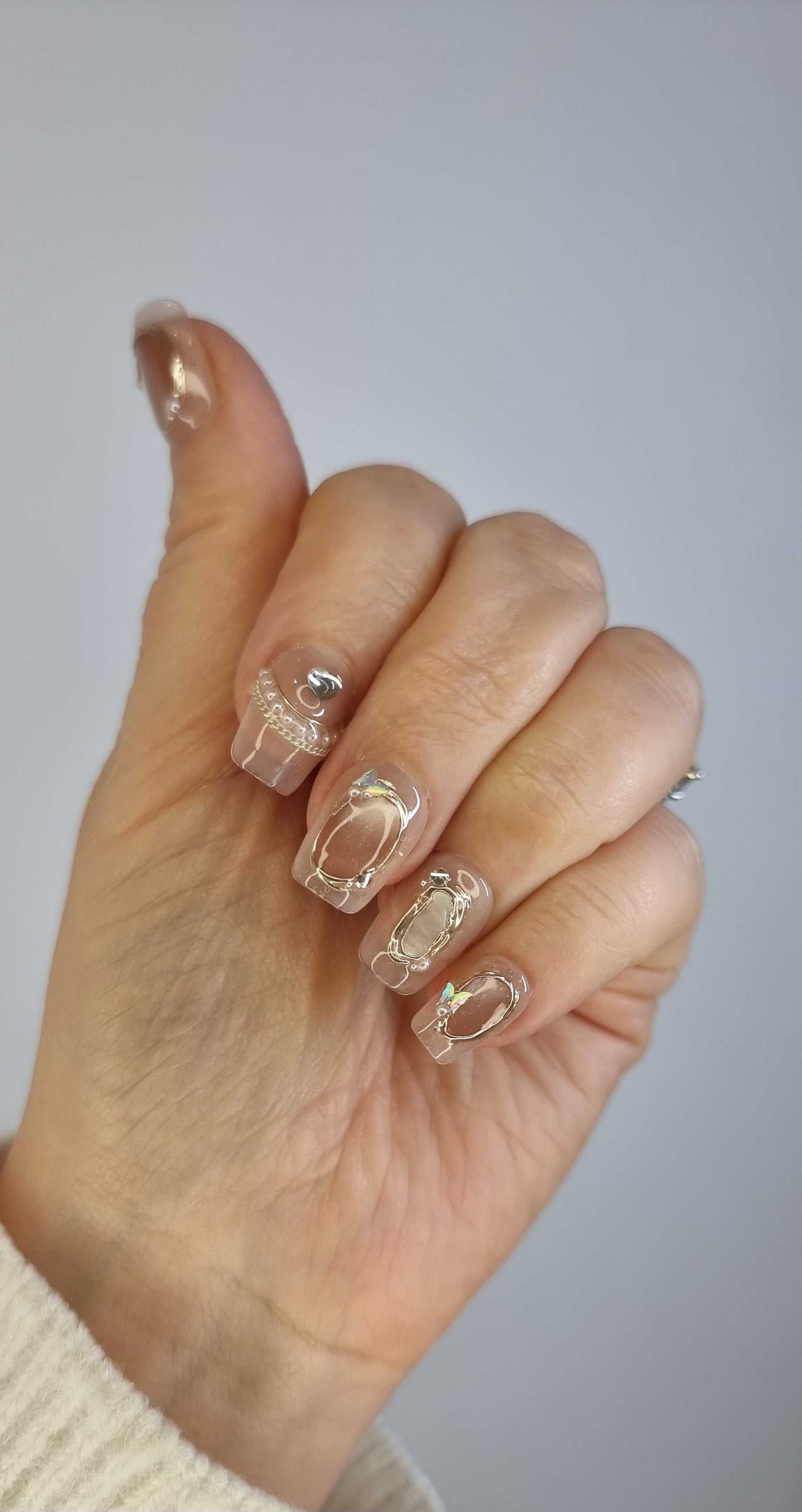 glossy coffin nails 2 Image showing a different angle of the Zaynah Short neutral-toned, glossy coffin nails.