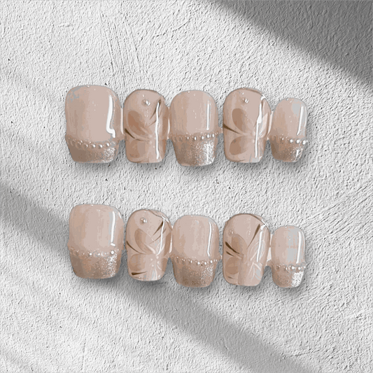 Full set of Zohra nude artificial nails with a glossy finish, displayed in the packaging Zohra luxury press on nails by Nailaddict UAE reusable glossy gel manicure