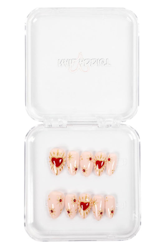Get the Valentine's Day look with these hand-painted coffin-shaped press-on nails. Featuring a pink base, gold accents, and a glossy 3D heart design.