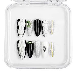 Ajman Aesthetic press-on nail set, long almond shape, nude and gold design.