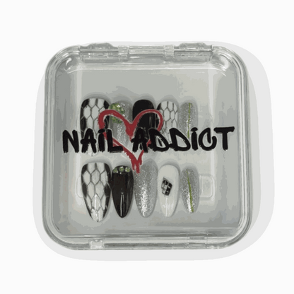 The branded Nail Addict packaging for the Ajman Aesthetic press-on nail set.