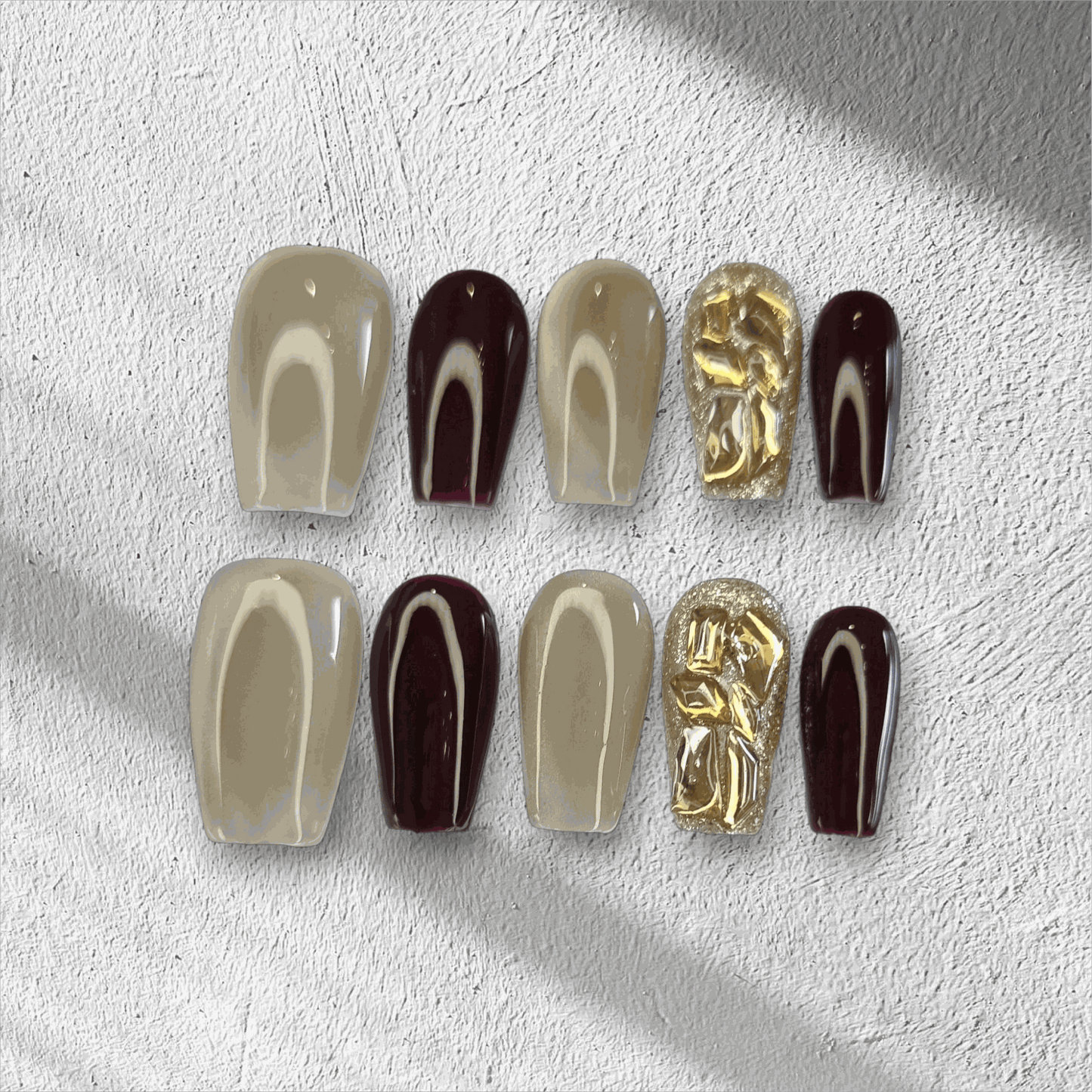  Amani nude and brown long coffin press-on nails by Nail Addict, with abstract heart patterns and solid accent nails