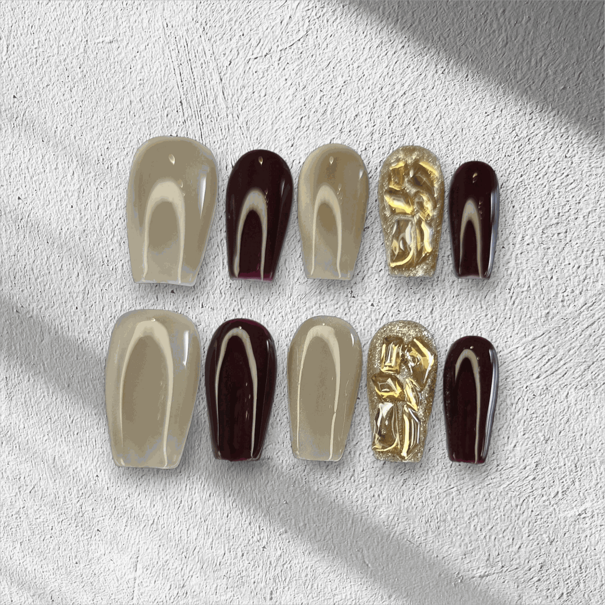 Amani nude and brown long coffin press-on nails by Nail Addict, with abstract heart patterns and solid accent nails