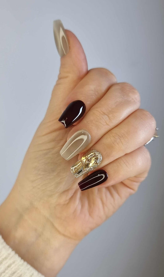 Hand wearing Amani press-on nails by Nail Addict, highlighting the elegant abstract pattern and long coffin shape.