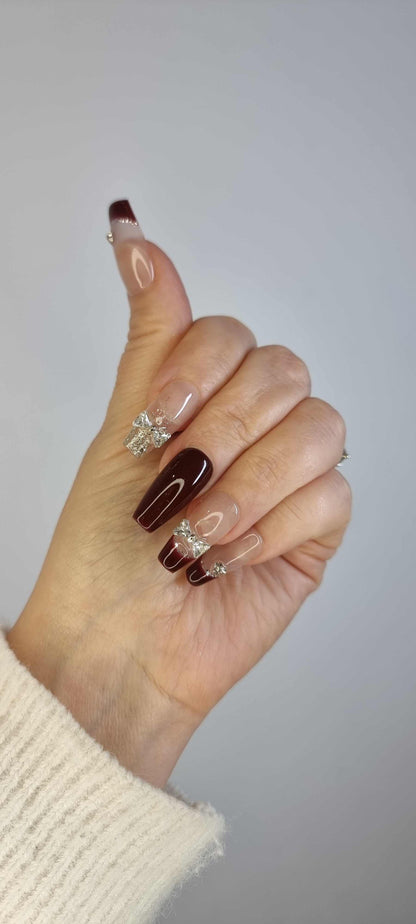 Close-up of Amira long press-on nail, highlighting the unique liquid chrome pattern and sparkling jewel embellishments.