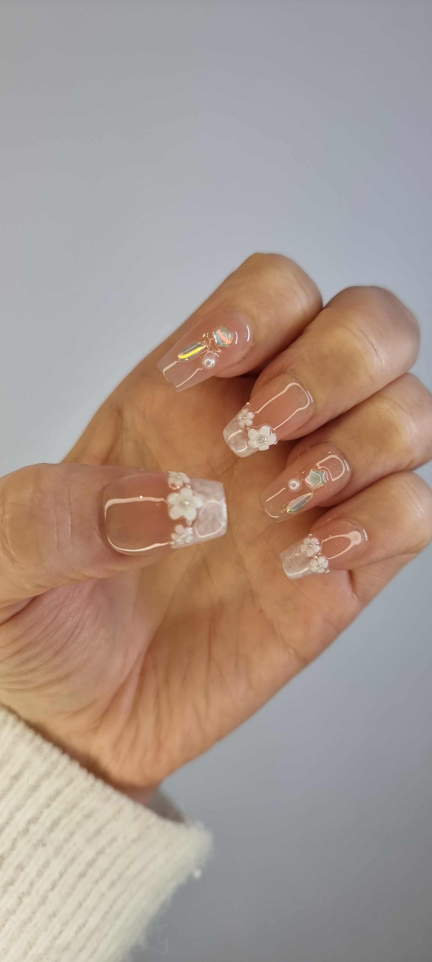 Hand wearing the Aziza or Selina short square press-on nails, showing the finished manicure.