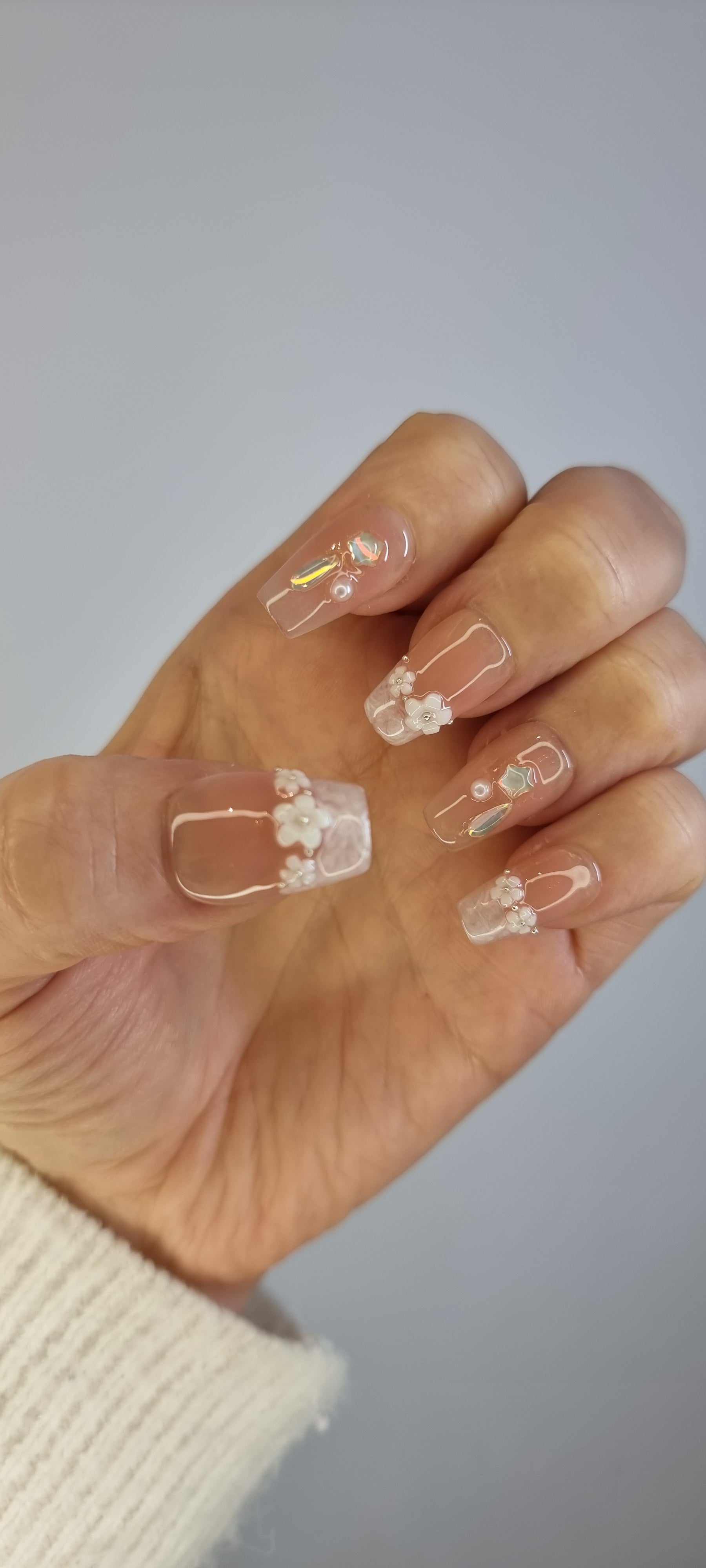 Hand wearing the Aziza or Selina short square press-on nails, showing the finished manicure.
