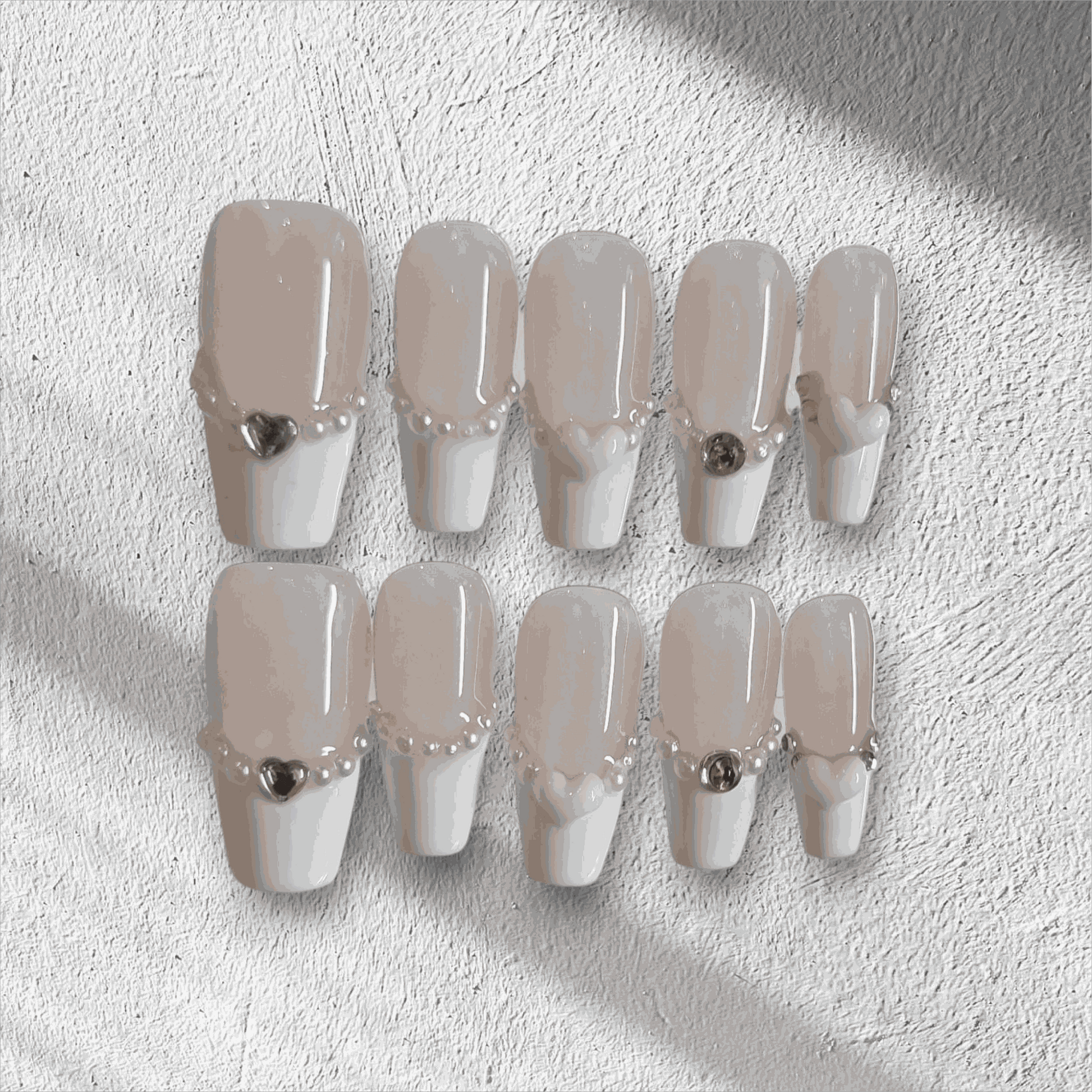 The Burj Beauty press-on nail set in a short square French manicure style.