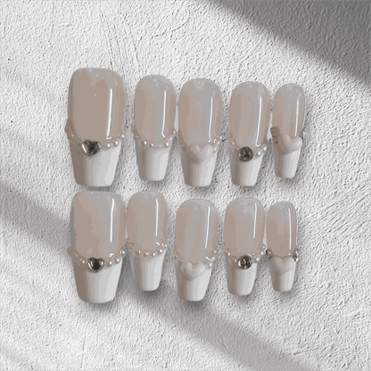 The Burj Beauty press-on nail set in a short square French manicure style.