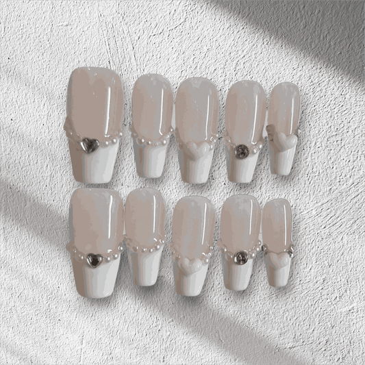 The Burj Beauty press-on nail set in a short square French manicure style.