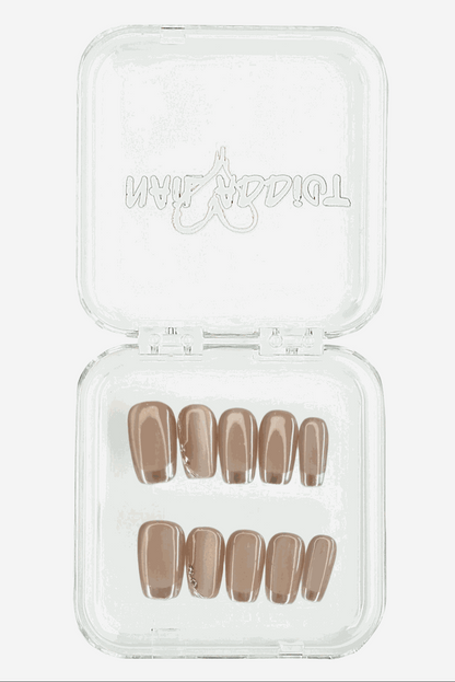Open clear plastic storage case with a full set of twenty press-on nails.