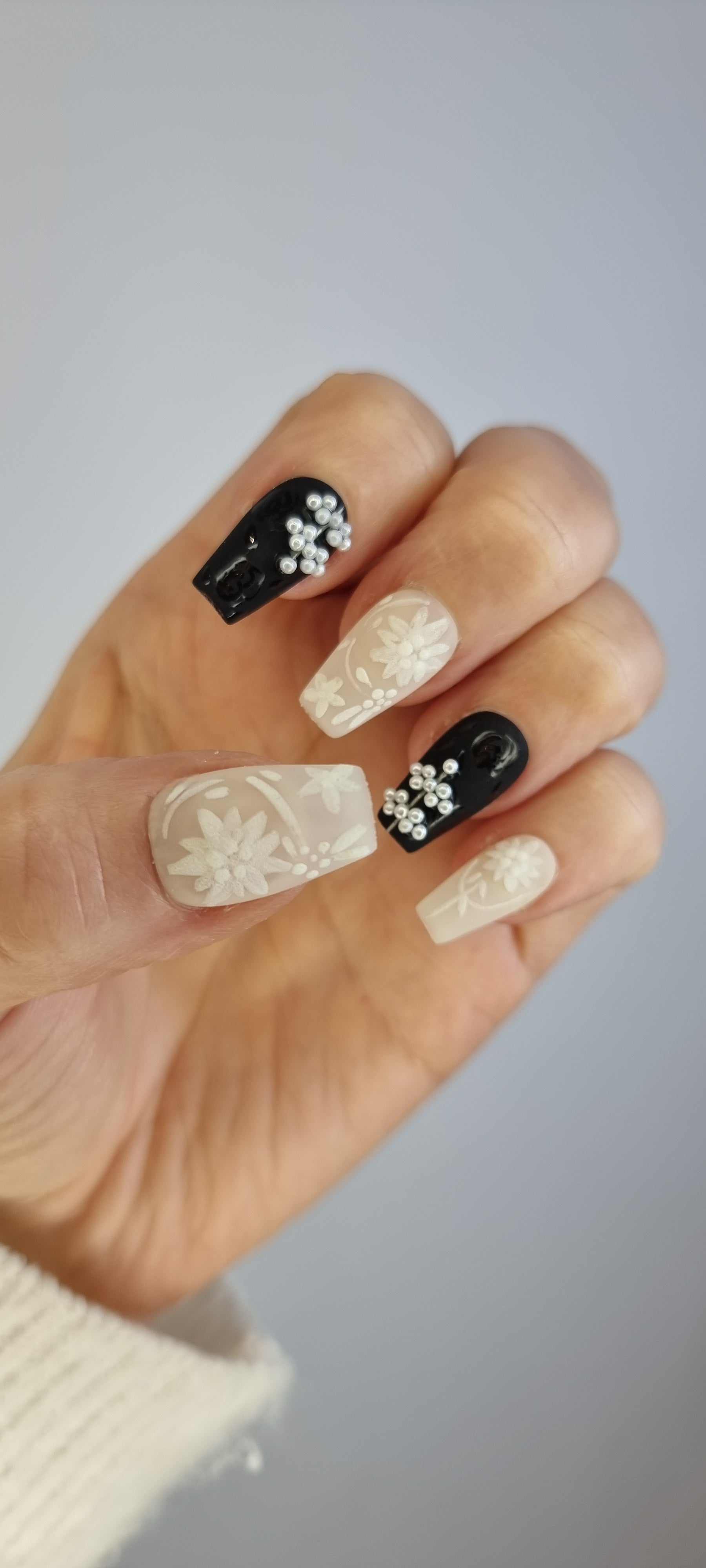 Hand wearing the Dalia long coffin press-on nails, showing the length and shape.