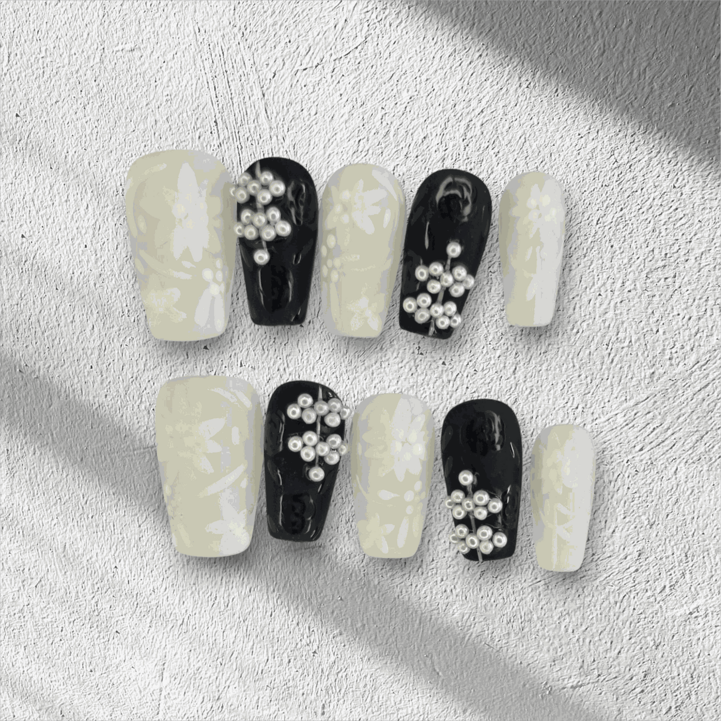 Full set of Dalia nude and brown long coffin press-on nails, displayed in the box.