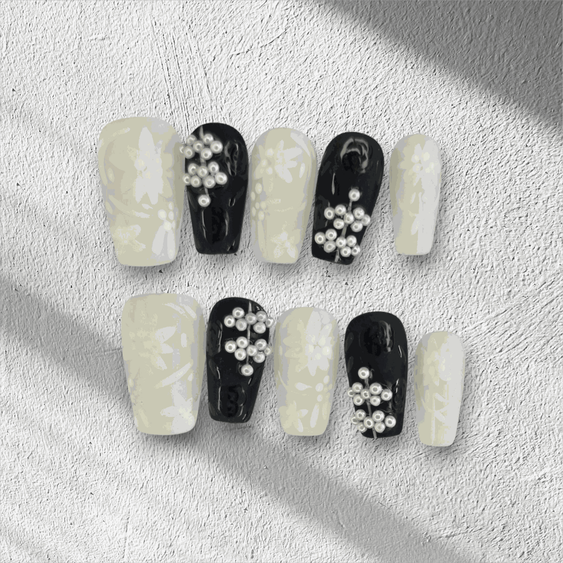 Full set of Dalia nude and brown long coffin press-on nails, displayed in the box.