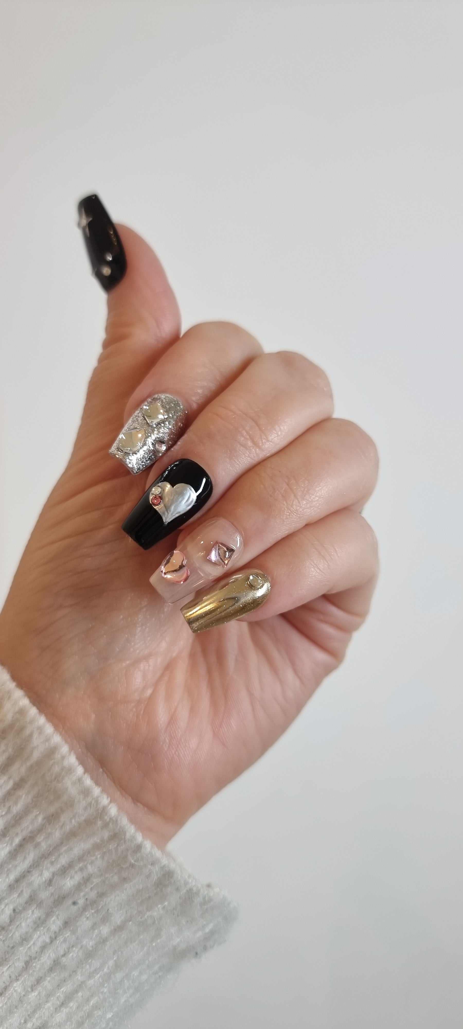 A close-up of the Doha Dreams manicure, highlighting the intricate 3D gem and star details on the coffin-shaped press-on nails.