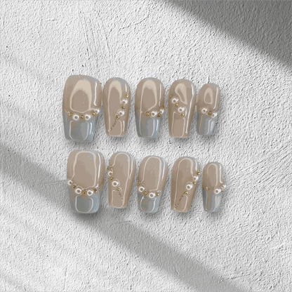 The Fadwa press-on nail set in a medium square shape with a blue French tip.