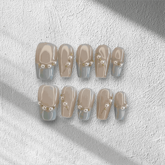 The Fadwa press-on nail set in a medium square shape with a blue French tip.