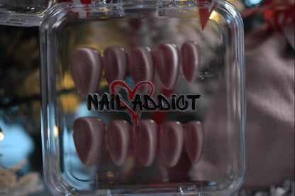 Clear case with pink nail tips and 'Nail Addict' branding.