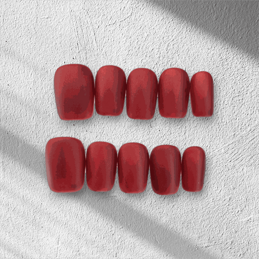 The Hessa press-on nail set in a short square shape, featuring a classic, bold red color with a modern matte finish.