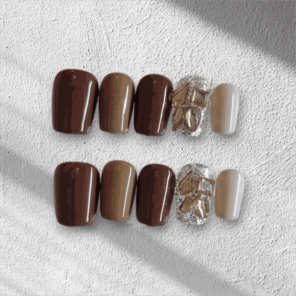 Jumeirah Glow brown and nude short square press-on nails by Nail Addict, featuring a statement gold foil and rhinestone accent nail.