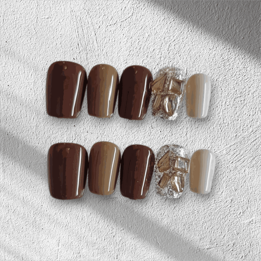 Jumeirah Glow brown and nude short square press-on nails by Nail Addict, featuring a statement gold foil and rhinestone accent nail.