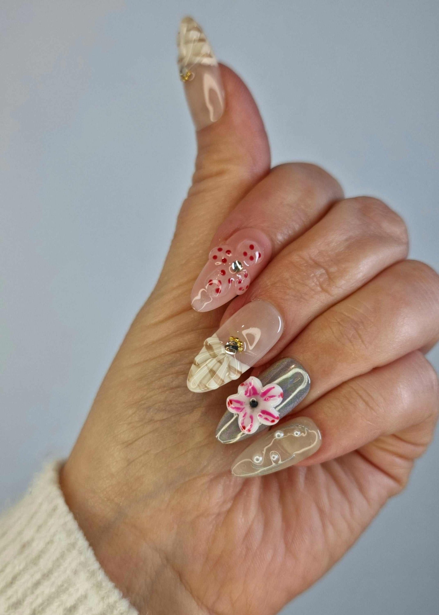 Madinah Majesty nude and black French tip square press-on nails by Nail Addict, featuring pearl accents and a white bow.