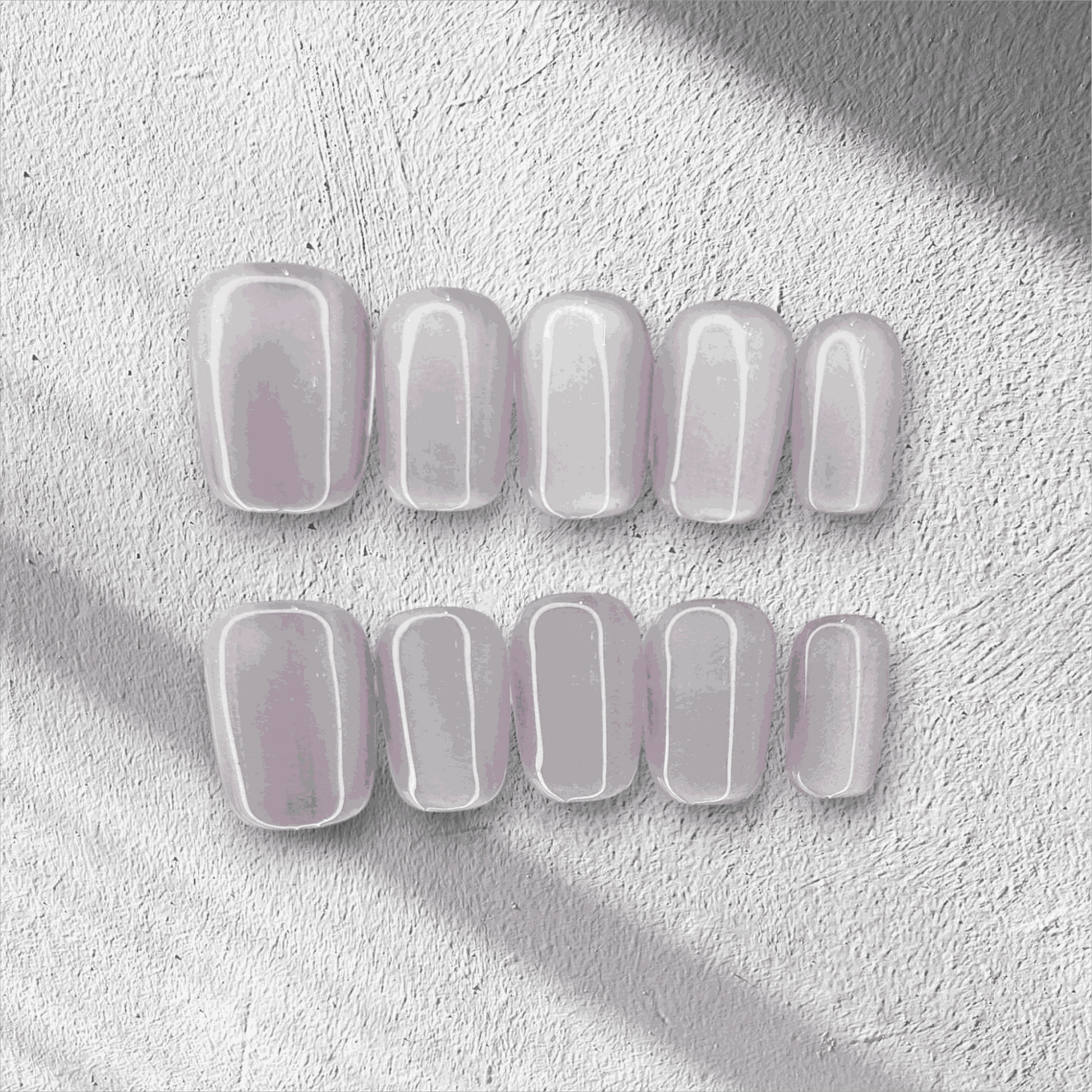 Manama Majesty pearlescent light purple short oval press-on nails by Nail Addict, with a glossy finish