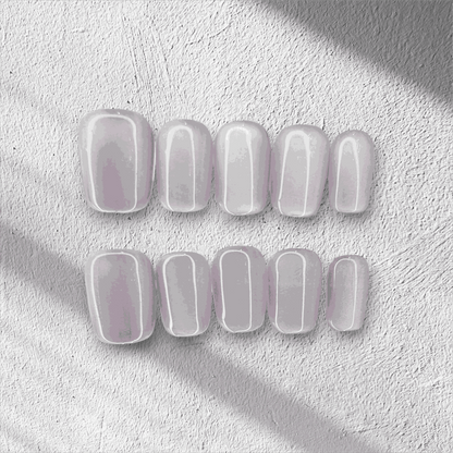 Manama Majesty pearlescent light purple short oval press-on nails by Nail Addict, with a glossy finish