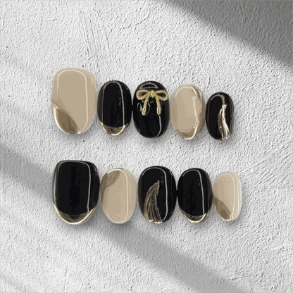 Full set of Muscat Mystique black and nude almond press-on nails displayed in the box.