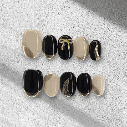 Full set of Muscat Mystique black and nude almond press-on nails displayed in the box.