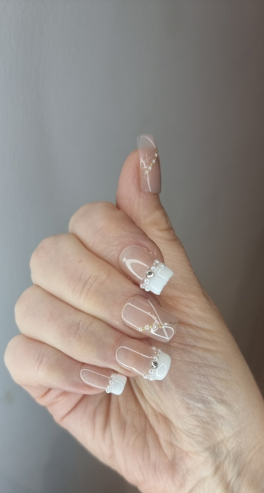 Hand wearing Nada press-on nails, applied by Nail Addict.