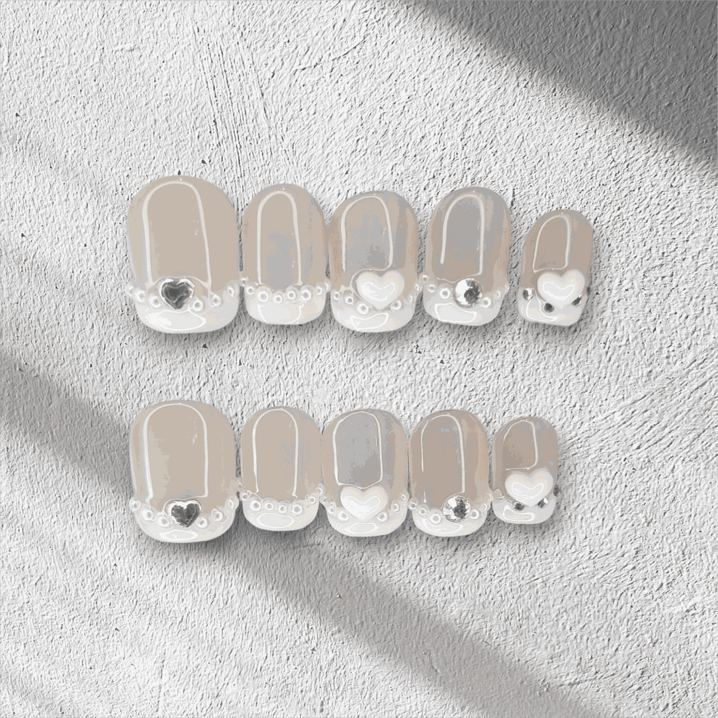  Nada pink French tip long coffin press-on nails by Nail Addict, with a white and gold glitter accent nail.