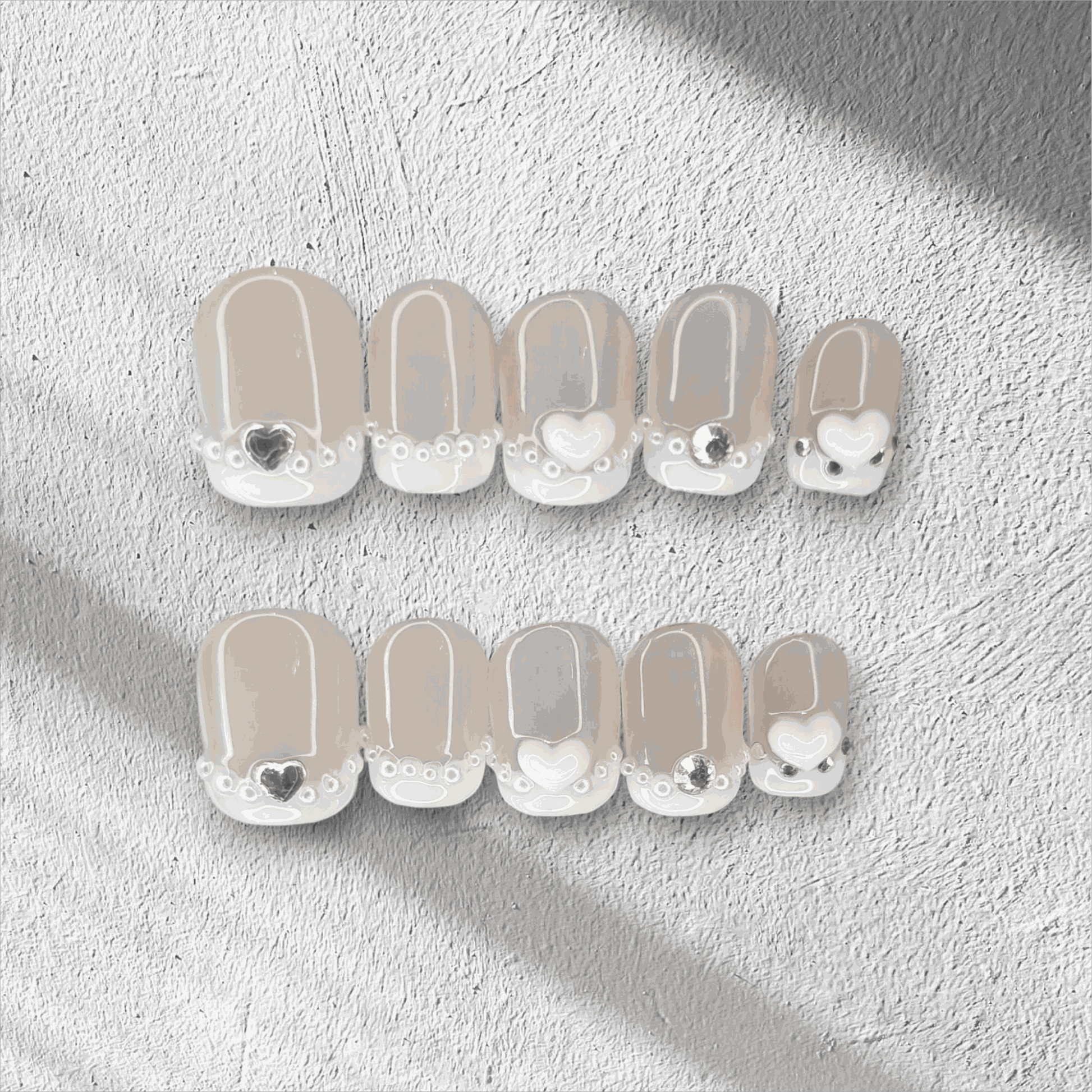  Nada pink French tip long coffin press-on nails by Nail Addict, with a white and gold glitter accent nail.