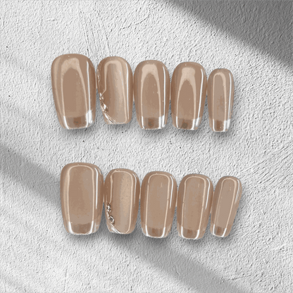 A flat lay of the long, glossy, clear nude Nahla press-on nail set displayed in the box.