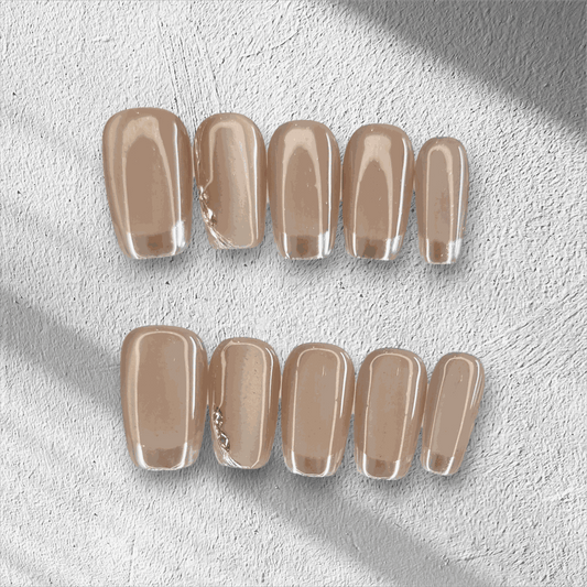 A flat lay of the long, glossy, clear nude Nahla press-on nail set displayed in the box.