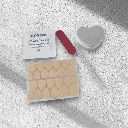 The contents of the Nail Addict press-on nail application kit, including glue and tools.