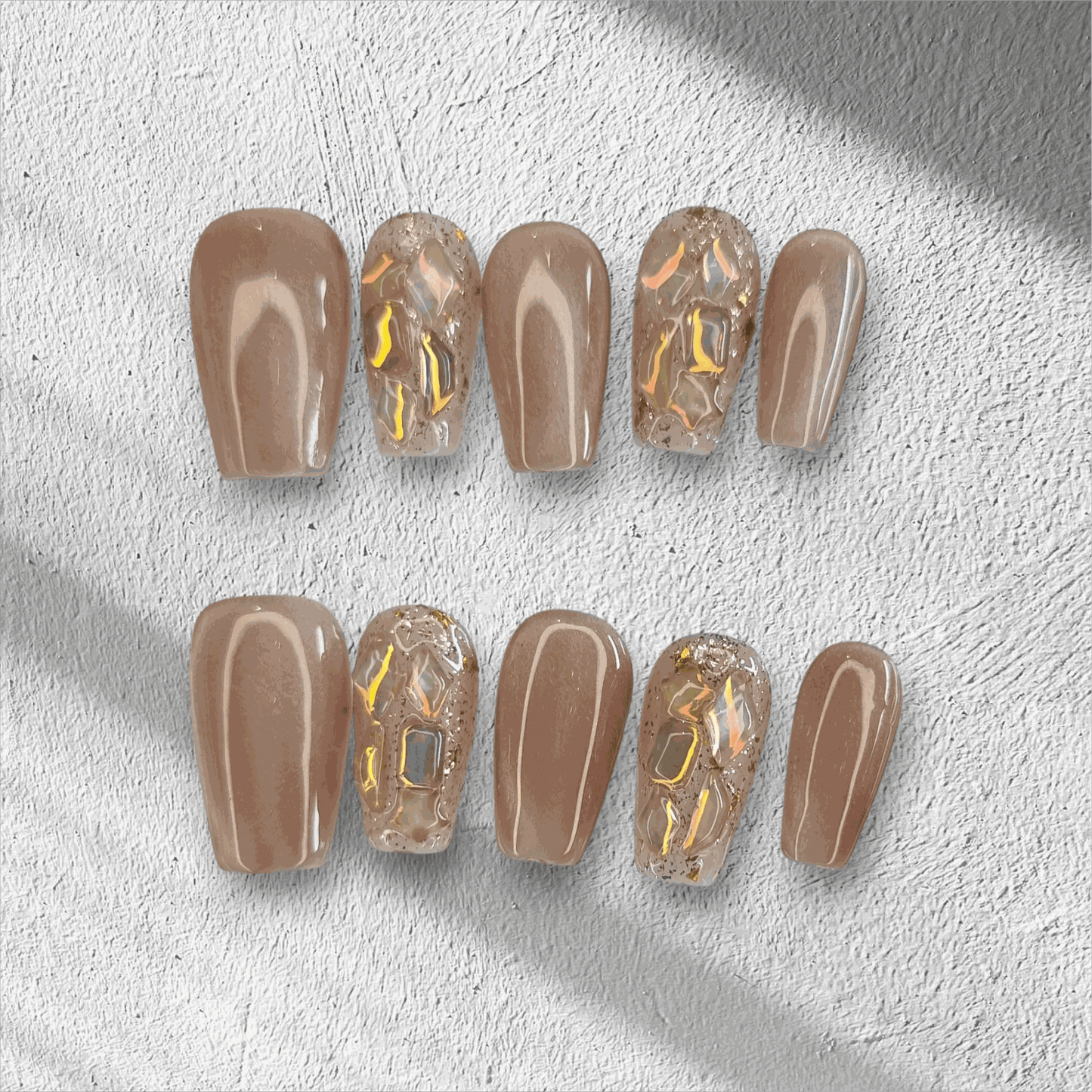 Full set of Najma almond-shaped press-on nails in two distinct colors displayed in the box.