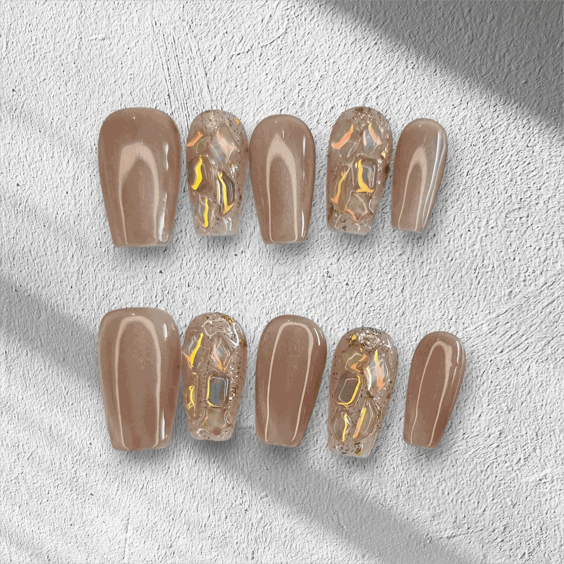 Full set of Najma almond-shaped press-on nails in two distinct colors displayed in the box.